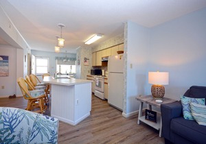 Nice 2 bedroom condo with pristine hardwood floors, free WiFi, and an outdoor pool located midtown and only a block to the beach!