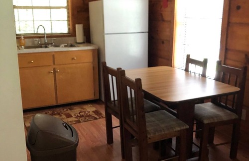 Oneida Cabin | cozy cabin in the woods in a relaxing area with wrap around porch rocking chairs