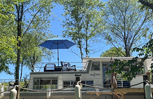 Langsville Boat Rental | Beached houseboat with lots of character and deck jacuzzi