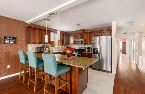 Newark House | Newark Gem Ruby 3BR, 3BA - Sleeps 14 - Walk to Prudential Center and Newark Penn Station, Near EWR and American Dream Mall, includes Parking - WiFi - Laundry - Backyard - Gym