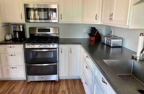 Huron House | Private heated pool in back & Sandy beach in front