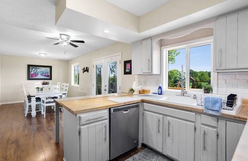 Huron House | Private ranch home with hot tub, playset, fire pit, and a nice lighted deck